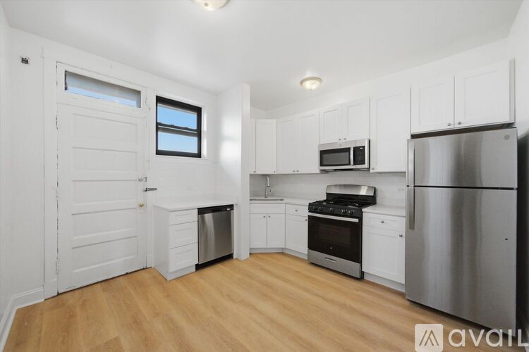 A kitchen with white cabinets and stainless steel appliances.