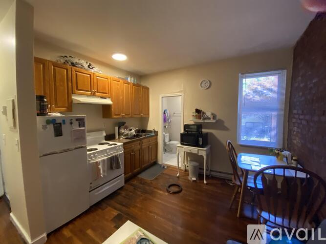 A kitchen with wooden cabinets and a white refrigerator.