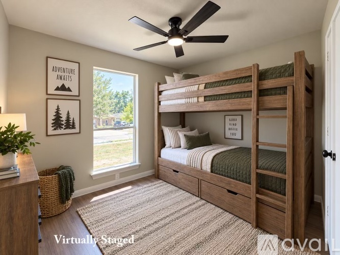 A room with a white door and wooden flooring.