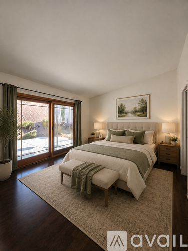 A bedroom with a large bed and a painting on the wall.