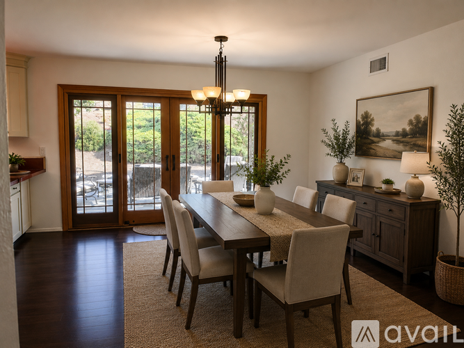 A dining room with a long table and chairs.
