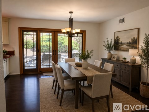 A dining room with a long table and chairs.
