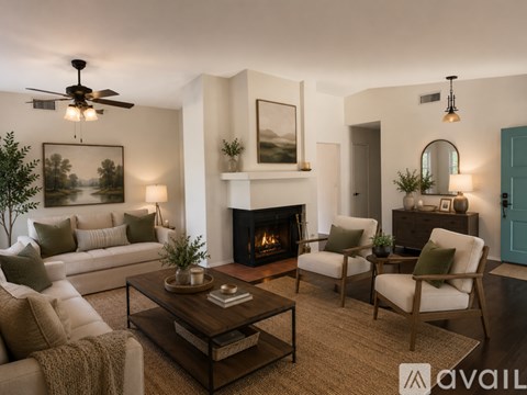 A living room with a fireplace, two chairs, a couch, and a coffee table.
