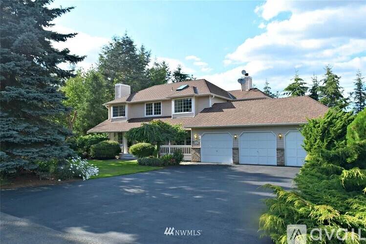 A large house with a driveway in front of it.