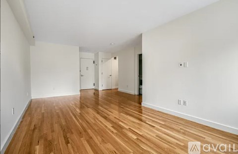 A room with wooden floors and white walls.