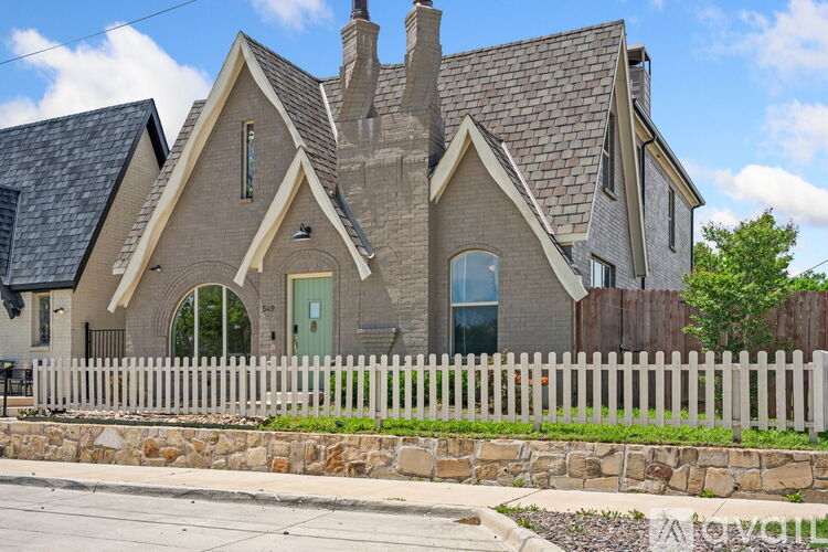A house with a white picket fence in front.