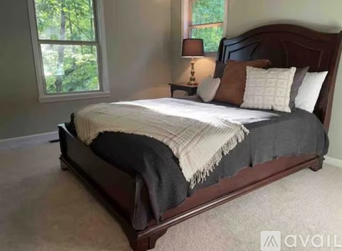 A bedroom with a large bed and a window.