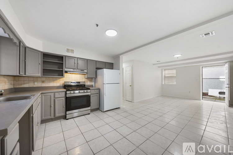 A kitchen with a white refrigerator and a stove top oven.