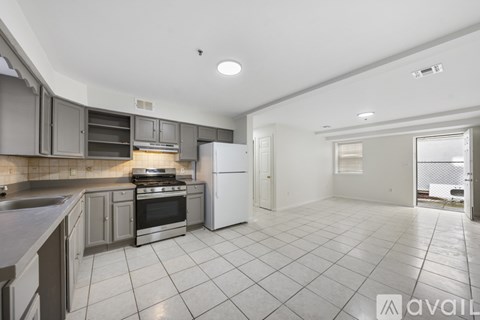 A kitchen with a white refrigerator and a stove top oven.