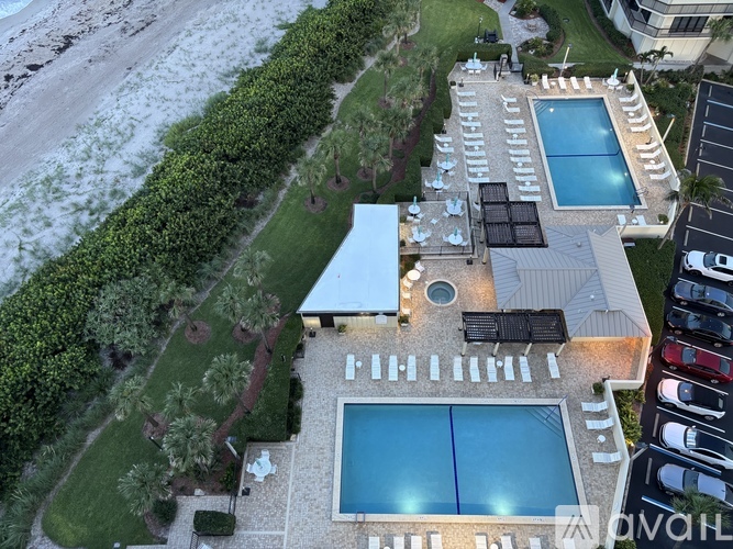 A bird's eye view of a house with a pool and a car parked in front.