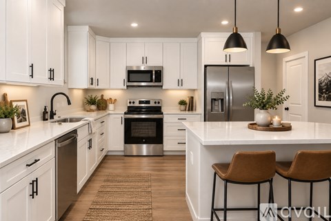 A modern kitchen with white cabinets and stainless steel appliances.