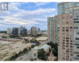 A cityscape with a mix of high-rise buildings and a parking lot.
