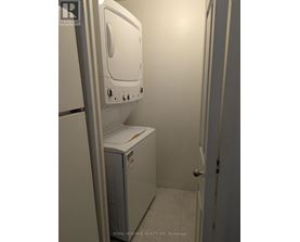 A white dryer is sitting in a small room.