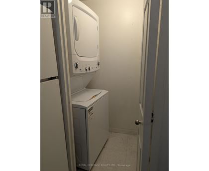 A white dryer is sitting in a small room.