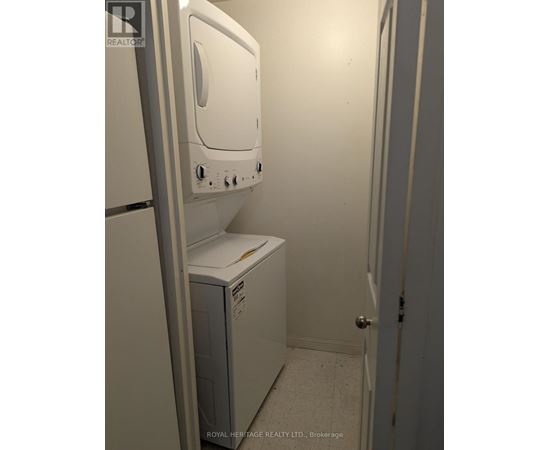 A white dryer is sitting in a small room.