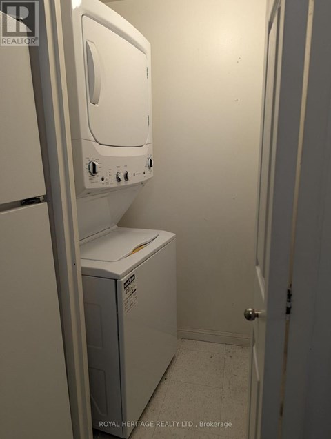 A white dryer is sitting in a small room.