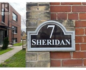 A sign with the number 7 and the word Sheridan on it.