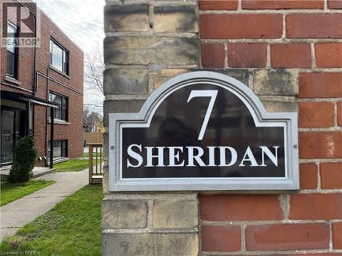 A sign with the number 7 and the word Sheridan on it.