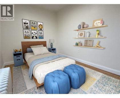 A bedroom with a bed, two blue ottomans, and shelves with decorative items.