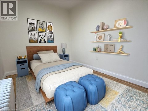 A bedroom with a bed, two blue ottomans, and shelves with decorative items.