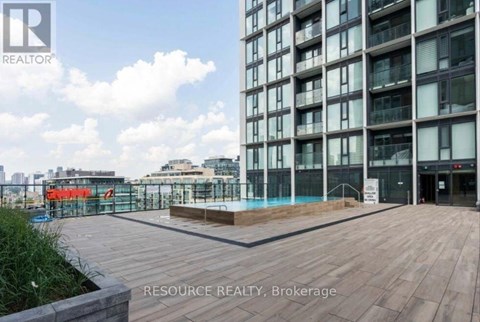 A modern building with a pool in the courtyard.
