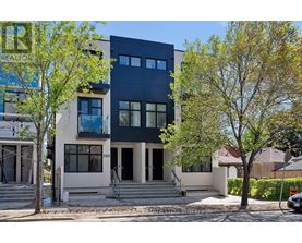 A modern two-story house with a black upper floor and a white lower floor.