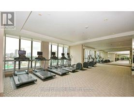 A gym with treadmills and a view of the city.