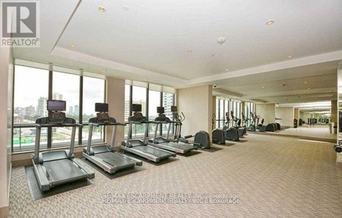 A gym with treadmills and a view of the city.