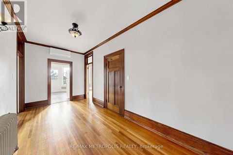 A room with wooden floors and white walls.