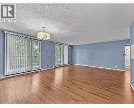 A room with wooden flooring and a ceiling fan.