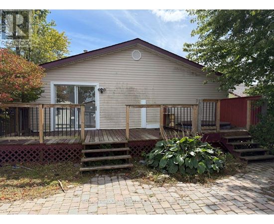 A small house with a red door and a porch.