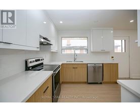 A modern kitchen with wooden cabinets and stainless steel appliances.