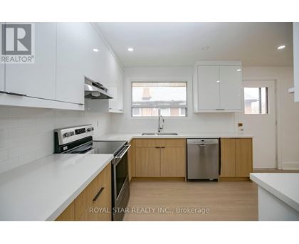 A modern kitchen with wooden cabinets and stainless steel appliances.