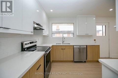 A modern kitchen with wooden cabinets and stainless steel appliances.