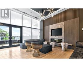 A modern living room with a large window and a flat screen TV.
