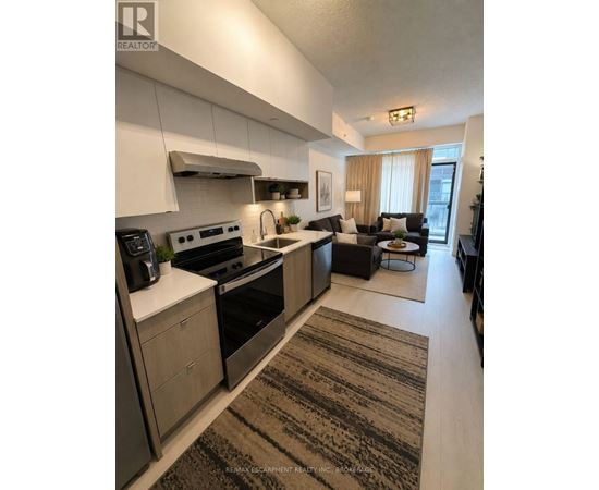 A modern kitchen with a large island and a dining area.