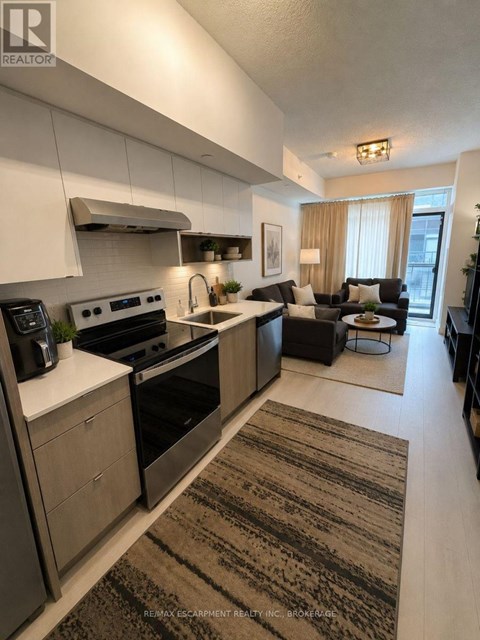 A modern kitchen with a large island and a dining area.