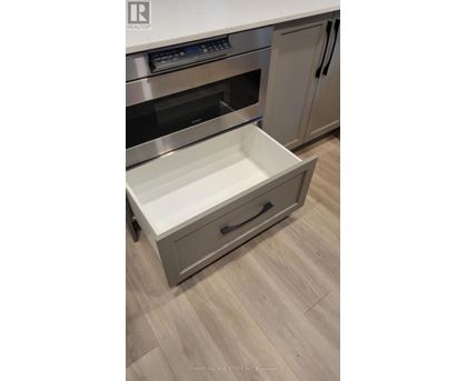 A stainless steel oven with a drawer in the front.