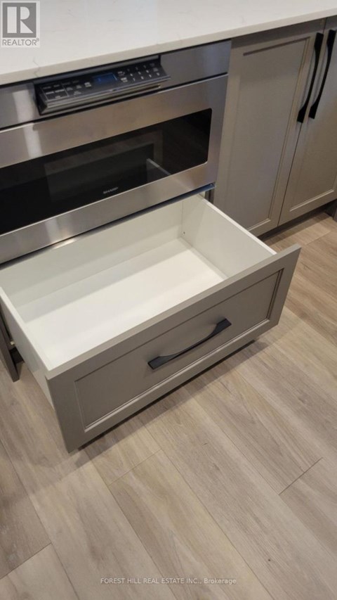 A stainless steel oven with a drawer in the front.