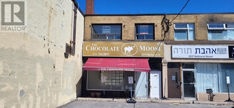 A building with a red awning and a sign that says "The Chocolate Moose".