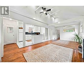 A spacious kitchen with white cabinets and a large island.