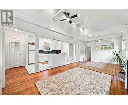 A spacious kitchen with white cabinets and a large island.