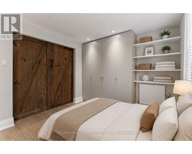 A bedroom with a large bed and a wooden door.