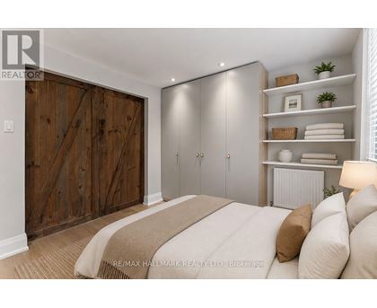 A bedroom with a large bed and a wooden door.