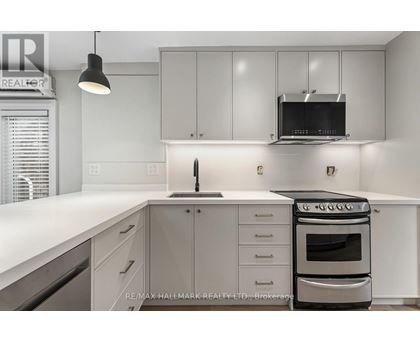 A modern kitchen with white cabinets and a stainless steel oven.
