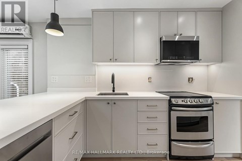 A modern kitchen with white cabinets and a stainless steel oven.
