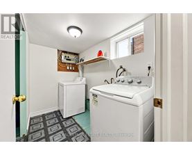 A small laundry room with a washer and dryer.