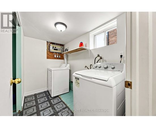 A small laundry room with a washer and dryer.