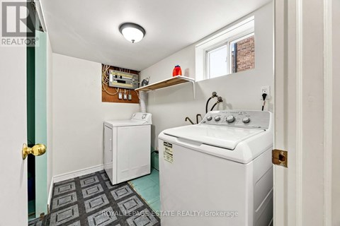 A small laundry room with a washer and dryer.