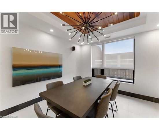 A modern dining room with a wooden table and chairs.